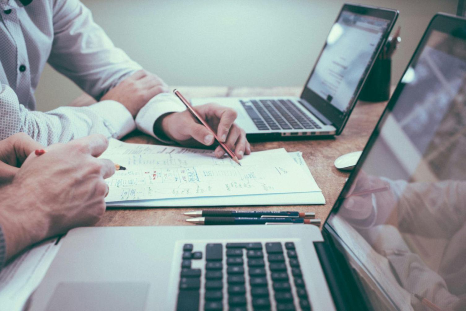 Financial analysis workspace with documentation and planning materials